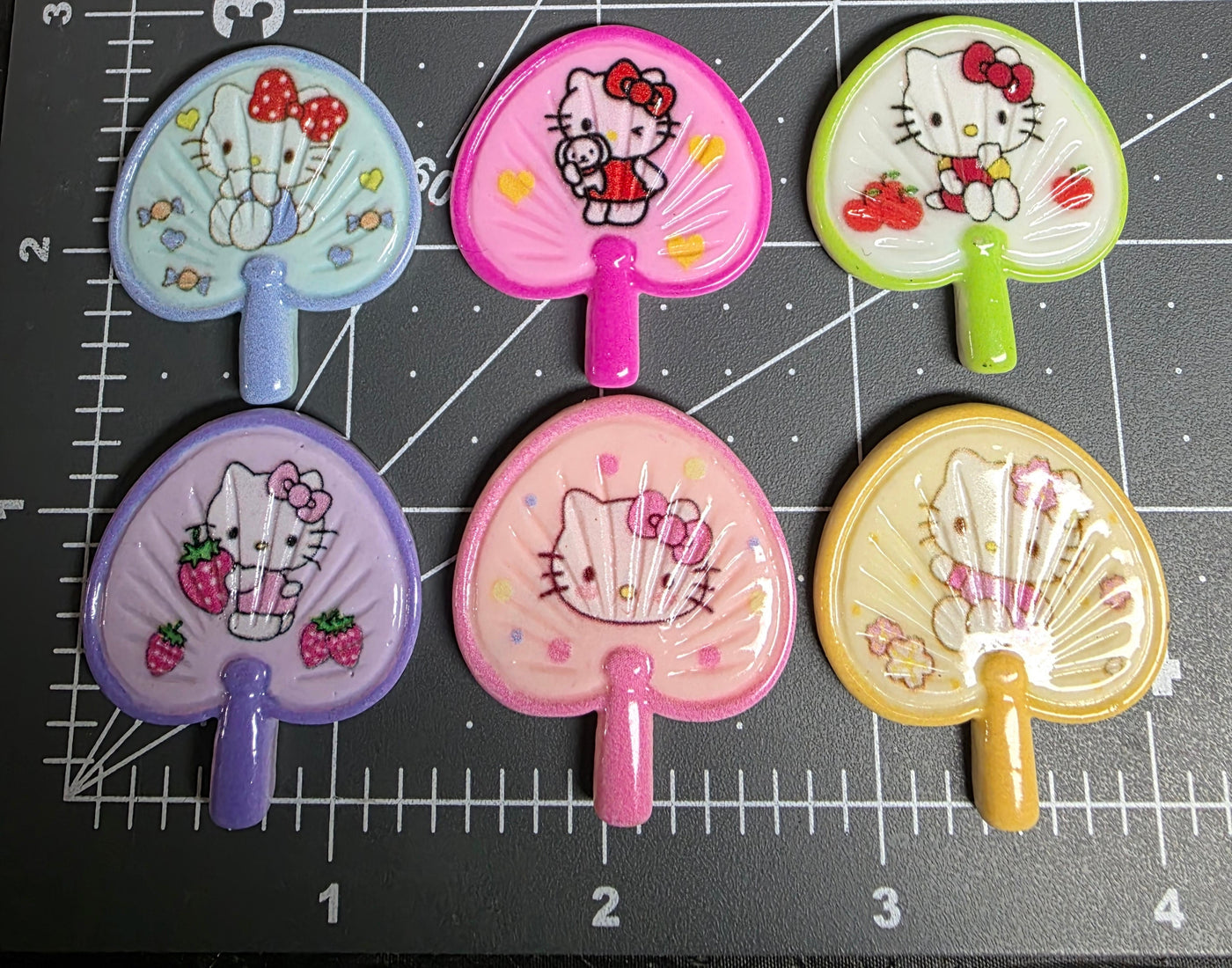 Set of Hello Kitty-themed hair clips on a grid background